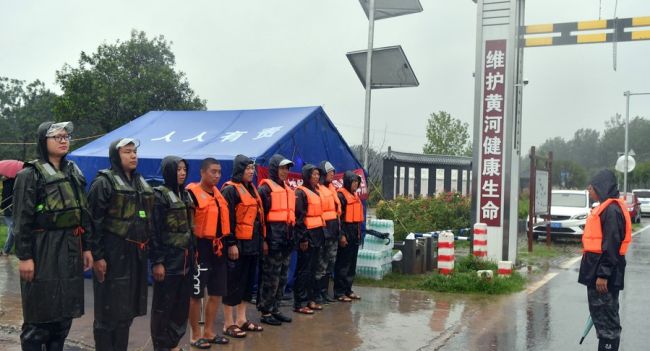 Εργαζόμενοι στην καταπολέμηση των πλημμυρών ετοιμάζονται για περιπολία του ποταμού Ντανχέ στο χωριό Τσεντζουάνγκ, πόλη Τζιάοζουο, επαρχία Χενάν της κεντρικής Κίνας, 20 Ιουλίου 2021. (φωτογραφία / Xinhua)